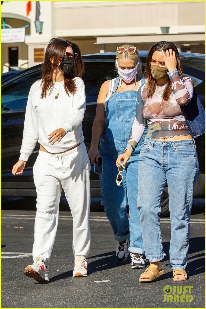 Emily Ratajkowski Cradles Baby Bump While Out with Friends