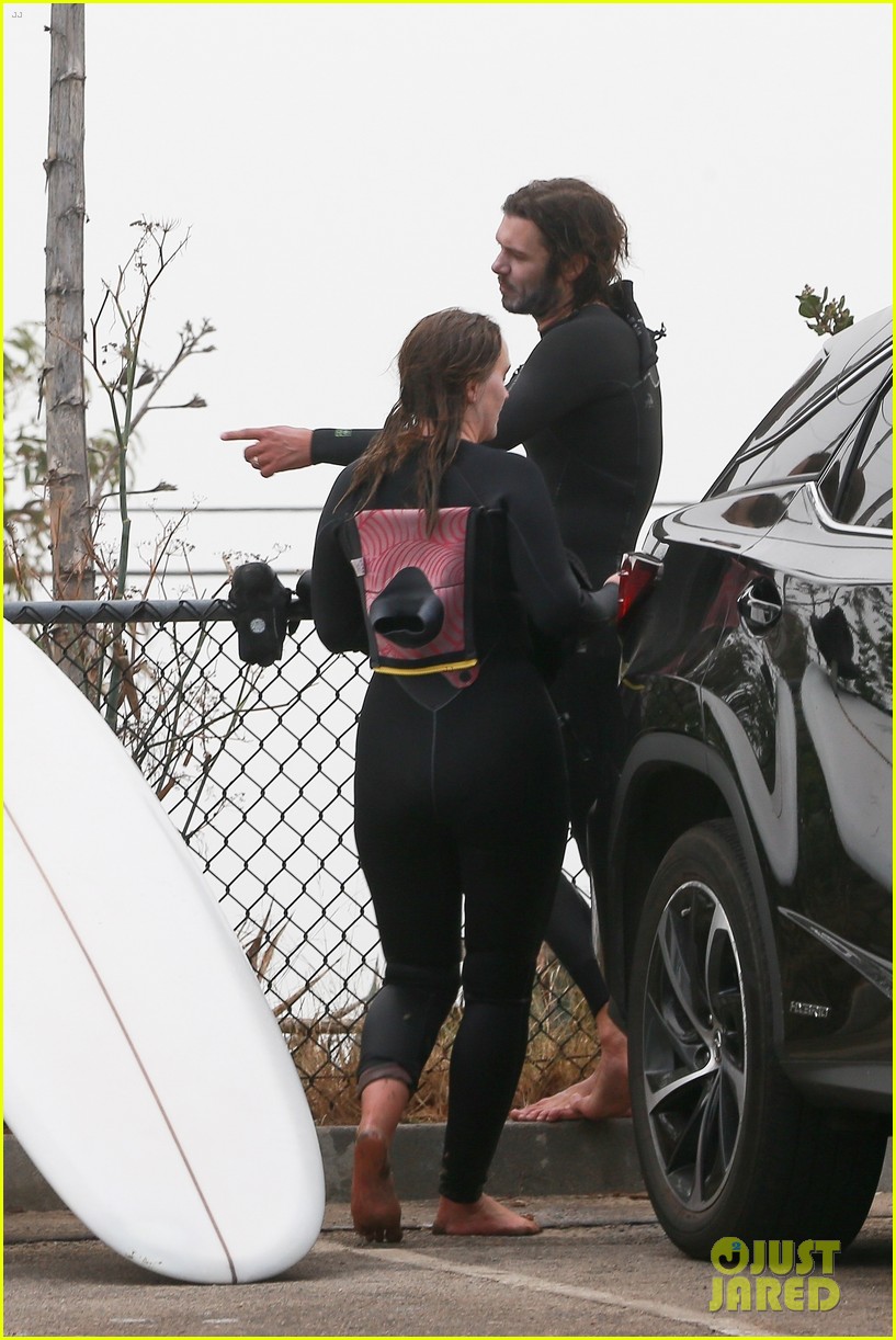 Leighton Meester & Adam Brody Adorably Hold Hands While Riding Their Surfboards in the Ocean