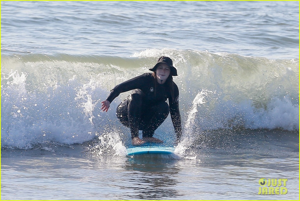 Leighton Meester & Adam Brody Adorably Hold Hands While Riding Their Surfboards in the Ocean