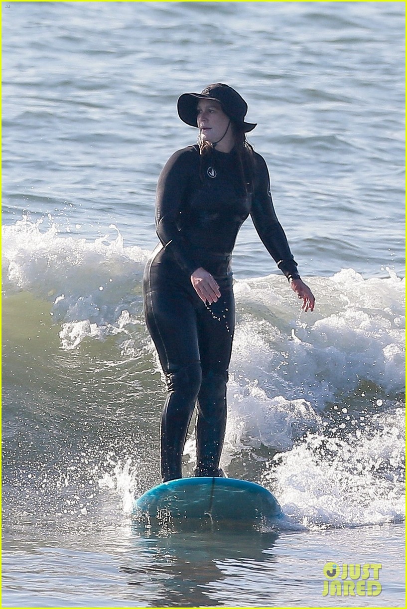 Leighton Meester & Adam Brody Adorably Hold Hands While Riding Their Surfboards in the Ocean