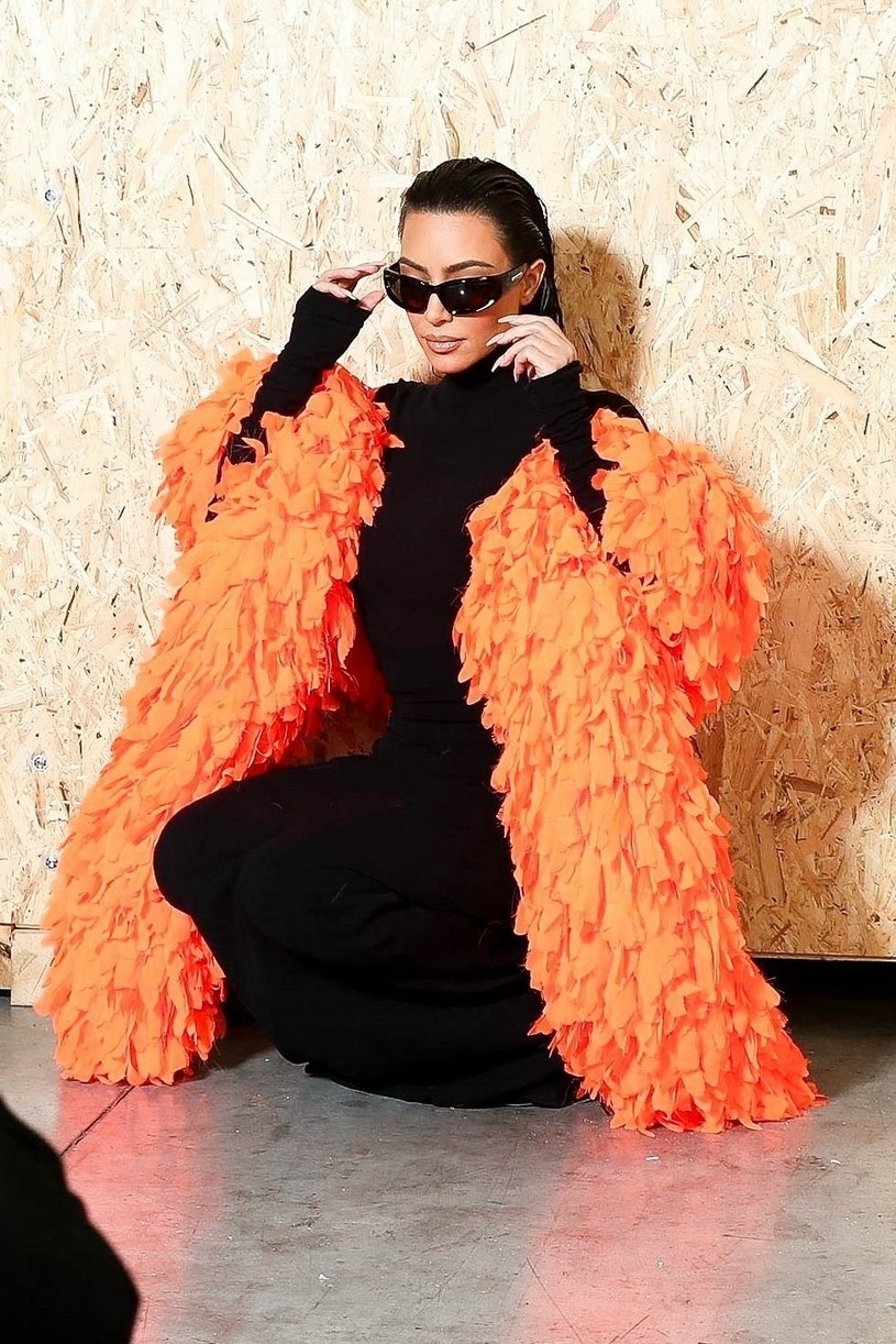Kim Kardashian Accessorizes With a Bright Orange Feather Boa at Balenciaga Show in Paris