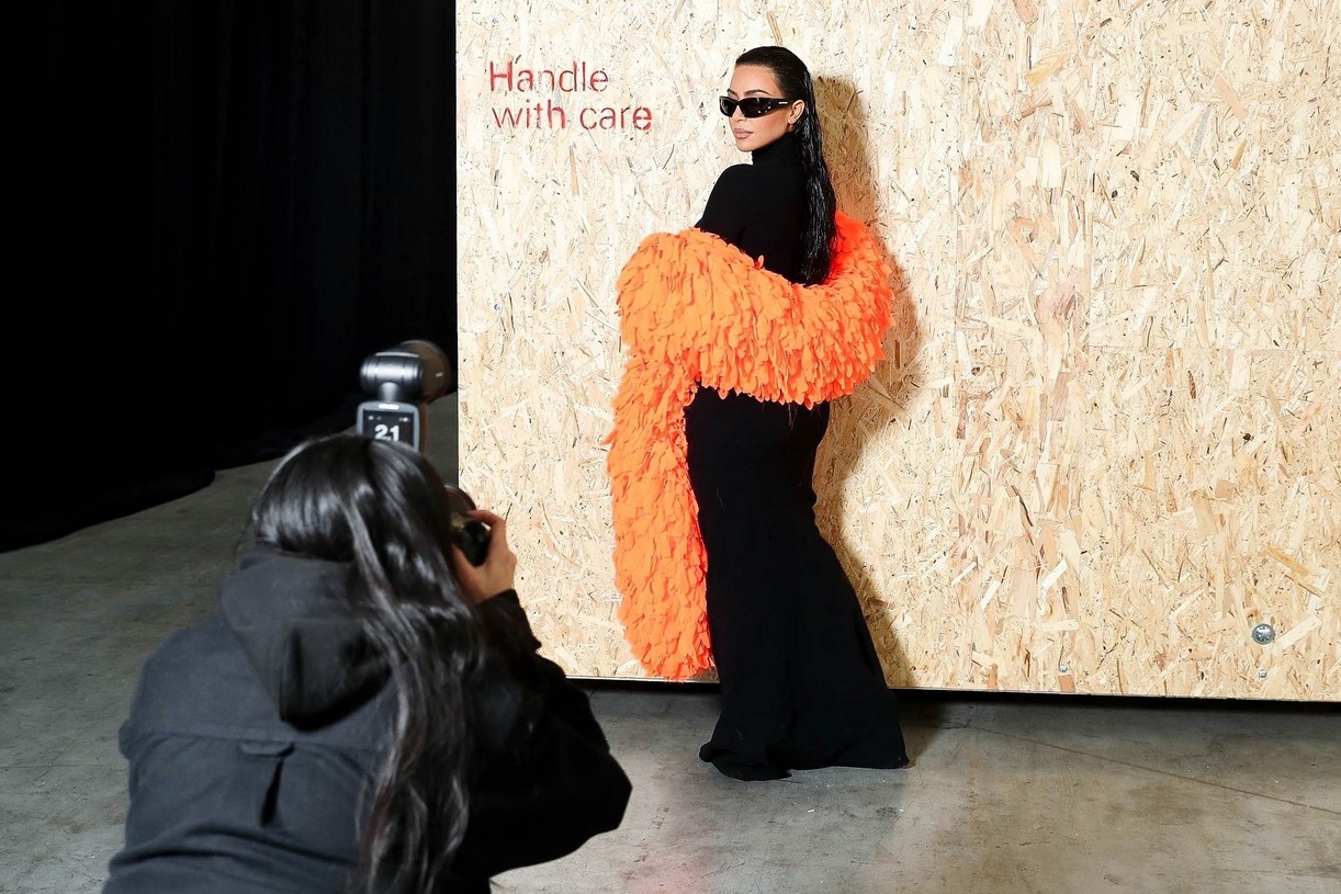 Kim Kardashian Accessorizes With a Bright Orange Feather Boa at Balenciaga Show in Paris